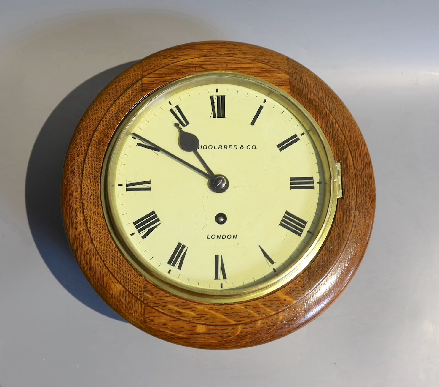 A late Victorian oak cased single fusee wall dial, marked Shoolbred & Co, London, dial 20cm diameter